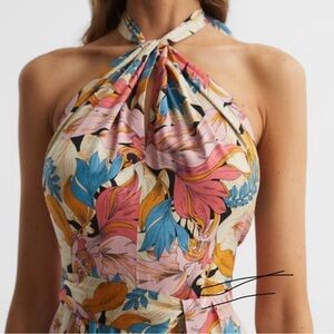 EMBRACE A FEMININE MOOD WITH THE FLORAL PRINTED AND CUT WITH A HALTER NECKLINE.